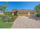 Beautiful home showcasing a terracotta roof, an integrated two-car garage, and a paver driveway at 6600 Horned Owl Pl, Sarasota, FL 34241
