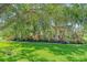 Exterior view of home with manicured lawn and mature landscaping at 6600 Horned Owl Pl, Sarasota, FL 34241