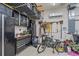 Organized garage space with black tool cabinets, overhead racks, and an air conditioning unit at 6600 Horned Owl Pl, Sarasota, FL 34241