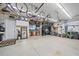 Spacious garage with epoxy flooring, ceiling storage, a refrigerator, and ample room for vehicles at 6600 Horned Owl Pl, Sarasota, FL 34241