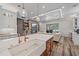 Open-concept kitchen and living room featuring a large island, modern appliances, and stylish decor at 6600 Horned Owl Pl, Sarasota, FL 34241