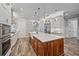 Open kitchen features a large center island with marble countertop, custom cabinets, and stainless steel appliances for style at 6600 Horned Owl Pl, Sarasota, FL 34241