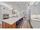 Spacious kitchen with a large island, white cabinets, and stainless steel appliances, seamlessly connecting to a dining room at 6600 Horned Owl Pl, Sarasota, FL 34241