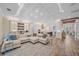 Spacious living area with a large sectional, bar, and open access to the modern kitchen and dining area at 6600 Horned Owl Pl, Sarasota, FL 34241