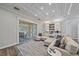 Bright living room with access to the outdoor pool area, featuring a comfortable sectional and stylish decor at 6600 Horned Owl Pl, Sarasota, FL 34241