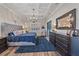 Spacious main bedroom with a tray ceiling, wood floors, and a sitting area at 6600 Horned Owl Pl, Sarasota, FL 34241