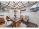 Home office with a tray ceiling, wainscoting, and stylish furniture at 6600 Horned Owl Pl, Sarasota, FL 34241