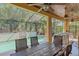 Covered outdoor dining area with a wood table and a screened pool in the background at 6600 Horned Owl Pl, Sarasota, FL 34241