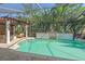 Private screened-in pool with tropical landscaping creating a backyard oasis for relaxing and entertaining at 6600 Horned Owl Pl, Sarasota, FL 34241