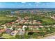 Aerial view of a community with lakes, trees, and well-maintained houses at 7913 Osprey Hammock Ct, Sarasota, FL 34240