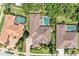 Aerial view of the property showcasing the pool, landscaping, and roof in a well-maintained neighborhood at 7913 Osprey Hammock Ct, Sarasota, FL 34240