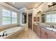 Luxurious bathroom with double vanity, soaking tub, and a walk-in shower at 7913 Osprey Hammock Ct, Sarasota, FL 34240