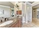 Elegant bathroom featuring a double vanity with granite countertop and tiled flooring at 7913 Osprey Hammock Ct, Sarasota, FL 34240