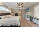 Large main bedroom boasts wood floors, a fireplace, and a stylish ceiling fan at 7913 Osprey Hammock Ct, Sarasota, FL 34240
