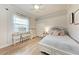Cozy bedroom with a neutral color scheme, desk, and ample natural light at 7913 Osprey Hammock Ct, Sarasota, FL 34240