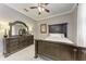 Bedroom featuring an intricate dark wood frame bed and decor mirror at 7913 Osprey Hammock Ct, Sarasota, FL 34240