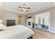 Spacious main bedroom featuring a fireplace, ceiling fan, and hardwood floors at 7913 Osprey Hammock Ct, Sarasota, FL 34240