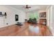 Spacious bonus room with hardwood floors, built-in bar, and french doors to the backyard at 7913 Osprey Hammock Ct, Sarasota, FL 34240