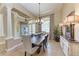 Formal dining room with stylish lighting, a large wooden table, and neutral decor at 7913 Osprey Hammock Ct, Sarasota, FL 34240