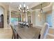 Elegant dining room showcasing a wooden table, chandelier, and architectural details at 7913 Osprey Hammock Ct, Sarasota, FL 34240