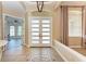 Elegant foyer featuring tile flooring, a chandelier, and double doors leading to an office at 7913 Osprey Hammock Ct, Sarasota, FL 34240
