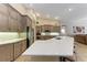 Bright kitchen featuring a large island, stainless steel appliances and custom cabinets at 7913 Osprey Hammock Ct, Sarasota, FL 34240