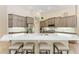 This kitchen features a large island with seating, stainless steel appliances and custom cabinets at 7913 Osprey Hammock Ct, Sarasota, FL 34240