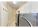 Well-organized laundry room featuring newer washer and dryer with ample storage space at 7913 Osprey Hammock Ct, Sarasota, FL 34240