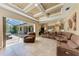 Open-concept living room with tiled floors and a sliding door to the outdoor living area at 7913 Osprey Hammock Ct, Sarasota, FL 34240