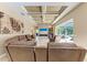 Expansive living room with access to patio and pool, featuring a stone accent wall at 7913 Osprey Hammock Ct, Sarasota, FL 34240