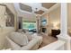 Elegant living room showcases a fireplace, wood floors, and a view of the outdoor pool area at 7913 Osprey Hammock Ct, Sarasota, FL 34240