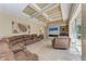 Spacious living room featuring a decorative ceiling and a stone-accented fireplace wall at 7913 Osprey Hammock Ct, Sarasota, FL 34240