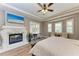 Main bedroom with a fireplace, tray ceiling, hardwood floors and ensuite seating at 7913 Osprey Hammock Ct, Sarasota, FL 34240