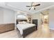 Main bedroom featuring light wood floors, neutral walls and an ensuite bathroom at 7913 Osprey Hammock Ct, Sarasota, FL 34240