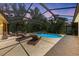 Private pool with screened enclosure, surrounding landscaping, and lounge seating at 7913 Osprey Hammock Ct, Sarasota, FL 34240