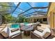 Screened in pool area featuring a hot tub and patio seating at 7913 Osprey Hammock Ct, Sarasota, FL 34240