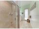 Luxurious tiled shower with frameless door at 7913 Osprey Hammock Ct, Sarasota, FL 34240