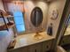 Bathroom featuring a vanity, large oval mirror, and decorative accents at 808 53Rd E Ave # 234, Bradenton, FL 34203