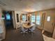 Well-lit dining area with a table for four, built-in display cabinet, and convenient access to the kitchen at 808 53Rd E Ave # 234, Bradenton, FL 34203