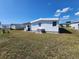Charming white mobile home with vinyl siding in a well-maintained community, featuring green lawn and blue skies at 808 53Rd E Ave # 234, Bradenton, FL 34203
