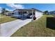Cozy single-story home features an attached carport, a tidy lawn, and a concrete driveway, providing convenience and curb appeal at 808 53Rd E Ave # 234, Bradenton, FL 34203