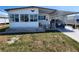 Charming single-story home featuring an attached carport, well-maintained lawn, and welcoming front porch at 808 53Rd E Ave # 234, Bradenton, FL 34203