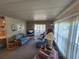 Relaxing living room featuring a comfortable sofa, an entertainment center, and sliding glass doors to let in natural light at 808 53Rd E Ave # 234, Bradenton, FL 34203