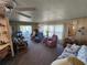 Comfortable living room with ceiling fan, plush seating, and sliding glass doors to the outdoor space at 808 53Rd E Ave # 234, Bradenton, FL 34203
