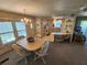 Bright living space featuring a dining table, adjacent to the kitchen, and a living area, perfect for seamless entertaining at 808 53Rd E Ave # 234, Bradenton, FL 34203