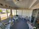 Sunroom features cozy furniture, carpet flooring, and ample natural light from many windows at 808 53Rd E Ave # 234, Bradenton, FL 34203