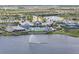 Stunning aerial view of community center featuring a luxurious pool, clubhouse, and lake with fountain at 8722 Backshore Ln, Parrish, FL 34219