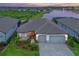 Stunning lakefront home featuring lush landscaping and a paver driveway at 8722 Backshore Ln, Parrish, FL 34219