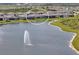 Scenic aerial view of a waterfront home in a peaceful community with lush landscaping and water feature at 8722 Backshore Ln, Parrish, FL 34219