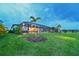 Lush green backyard with a screened-in pool and patio area, perfect for outdoor entertaining at 8722 Backshore Ln, Parrish, FL 34219